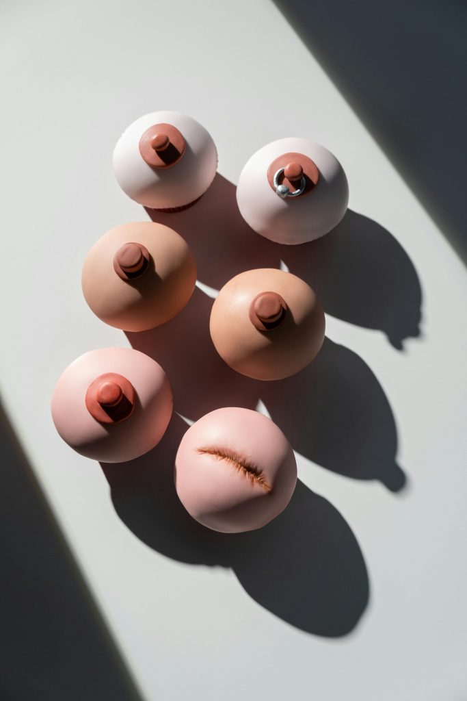 Creative cupcake art promoting breast cancer awareness with unique designs.